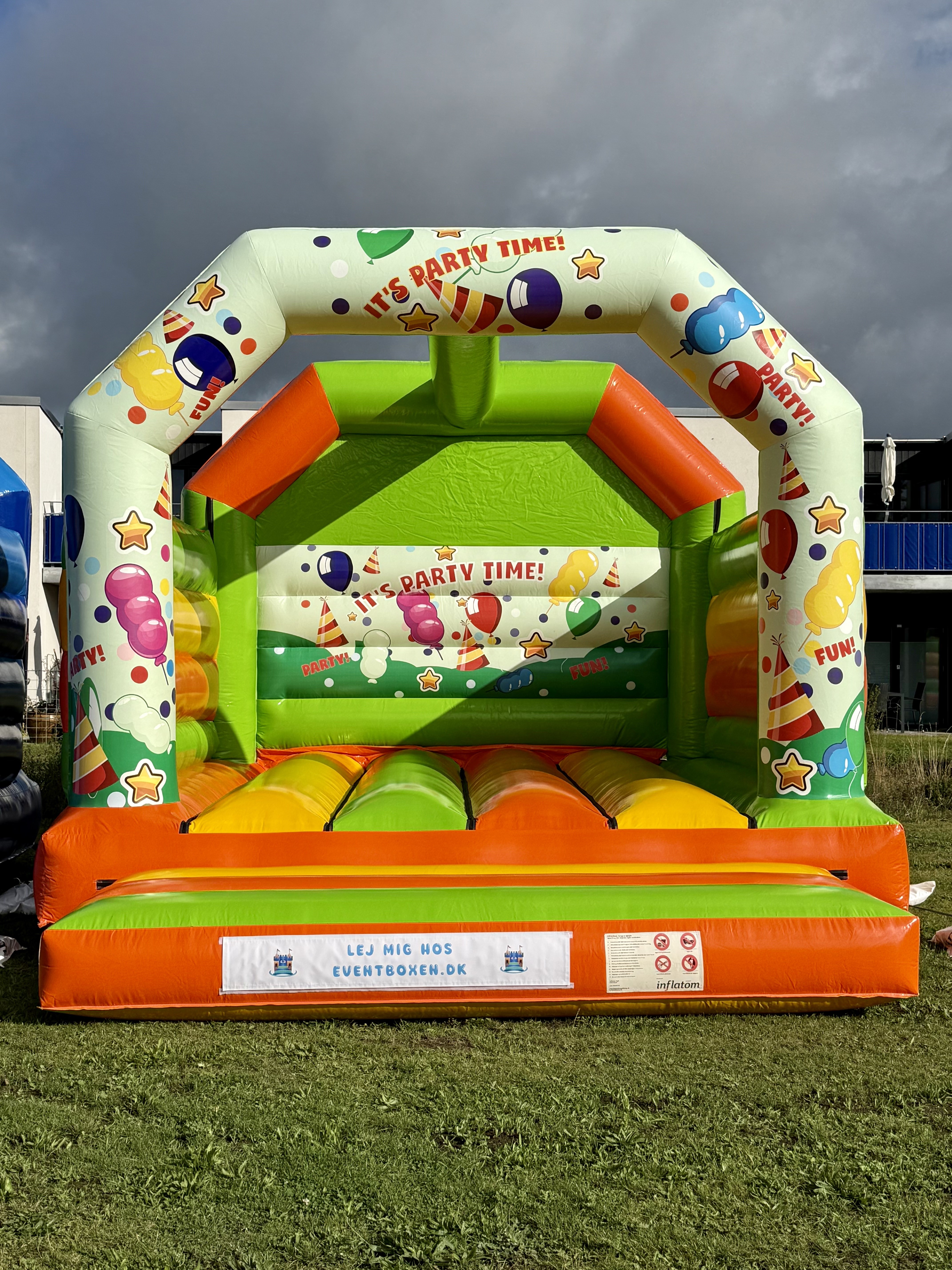 Eight shirts arranged on table in black, olive, grey, blue, white, red, mustard, and green.